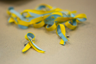 Small ribbon pins in the Ukrainian colors were also available.