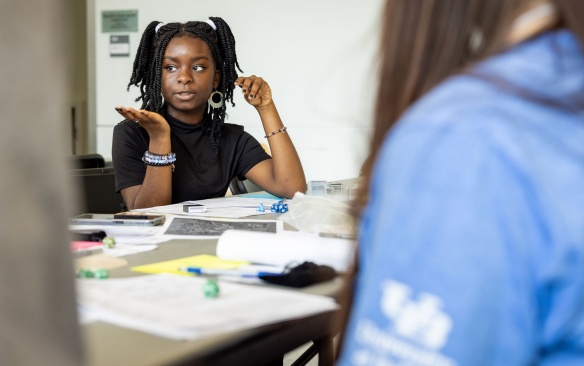Diverse pair of students in deep discussion in class.