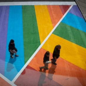 Students walking an a road painted in rainbow colors. 