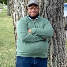 Gary Crump standing outside in front of a tree. 