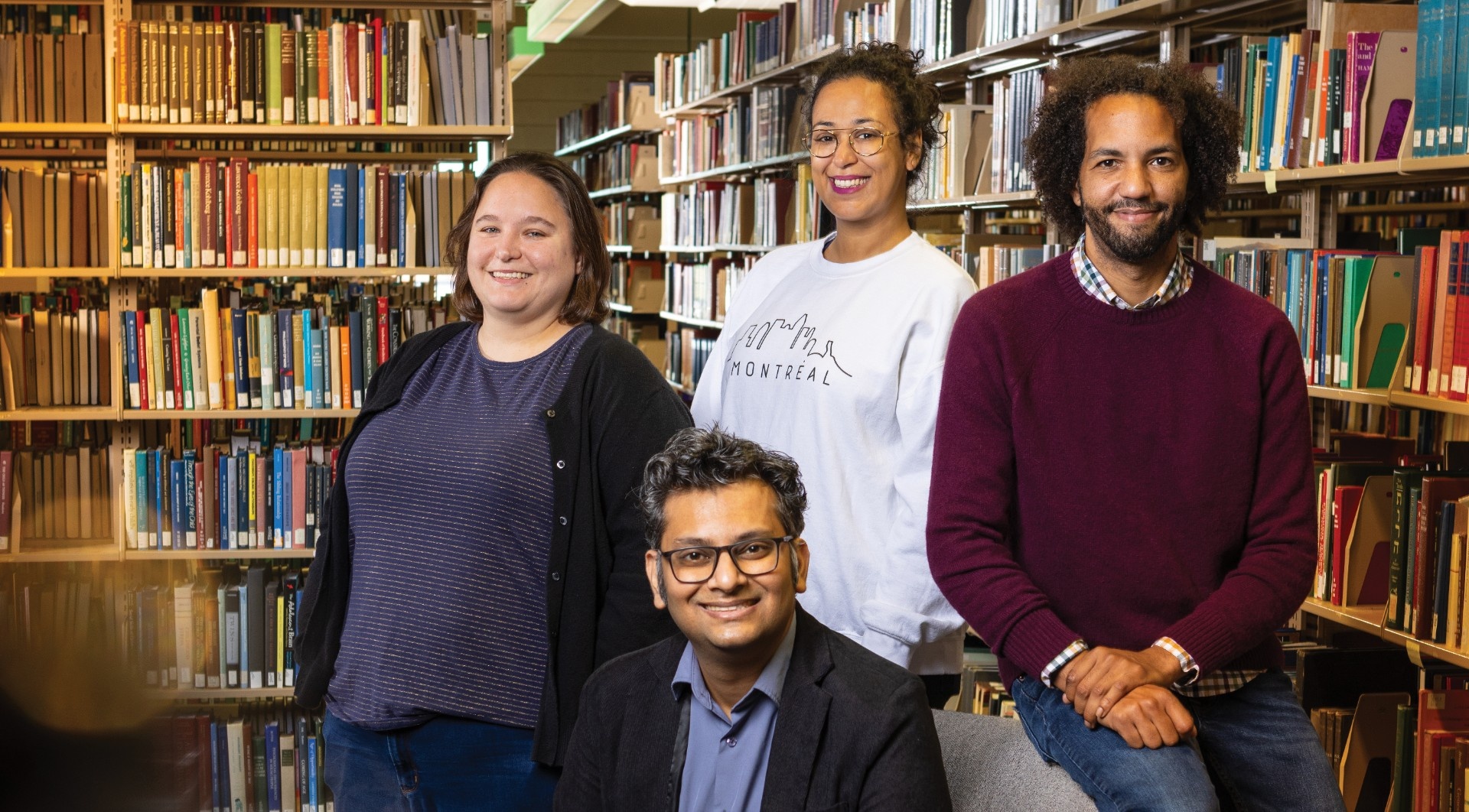 Four GSE PhD students in Lockwood Library: Sara Kieffer, Najat Sghyar, Richard Williams and Ashfique Rizwan. 