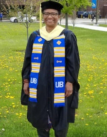 Zoom image: Gina Nortonsmith in her UB sash and PhD graduation attire