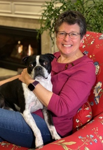 Headshot of Val Nesset with her dog, Wellie. 