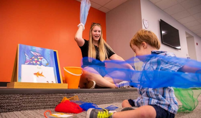 Image of teachers working with students. 