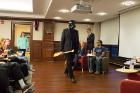 Appropriately dressed as Darth Vader, Will Kinney, professor of physics and winner of last year's debate, served as the devil's advocate. He carries the oar, the winner's trophy. Photo: Douglas Levere