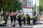 Emergency responders run down Washington Street between Carlton and High streets.