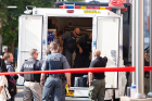 Police gather at a mobile command center.