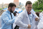 Seth P. Butler, a trainee in the emergency medicine residency program, cannot contain his delight as he dons his long white coat for the first time. Photo: Sandra Kicman