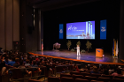 Lia Sitrin, an orientation staff member, addresses future students in the Center for the Arts Mainstage Theatre. Sitrin recently graduated from UB and this is her third summer working with orientation students.