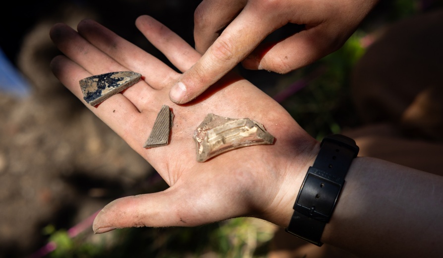 Members of the Archaeological Survey, a group led by Douglas Perrelli with the department of anthropology, works on a dig site at the Michigan St. Baptist Church in Buffalo, NY in July 2024. They have uncovered numerous items each day of the dig. Photographer: Meredith Forrest Kulwicki. 