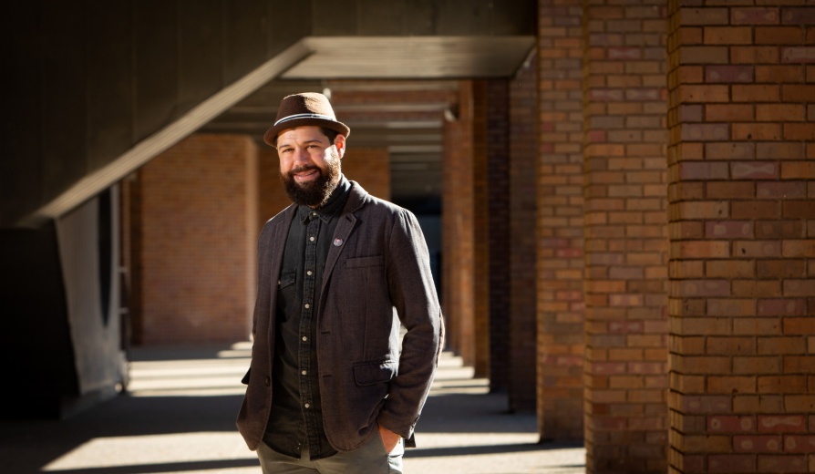 Portrait of Tim Monreal, a new professor in the Graduate School of Education, photographed outside O’Brian Hall in October 2022. Photographer: Meredith Forrest Kulwicki. 