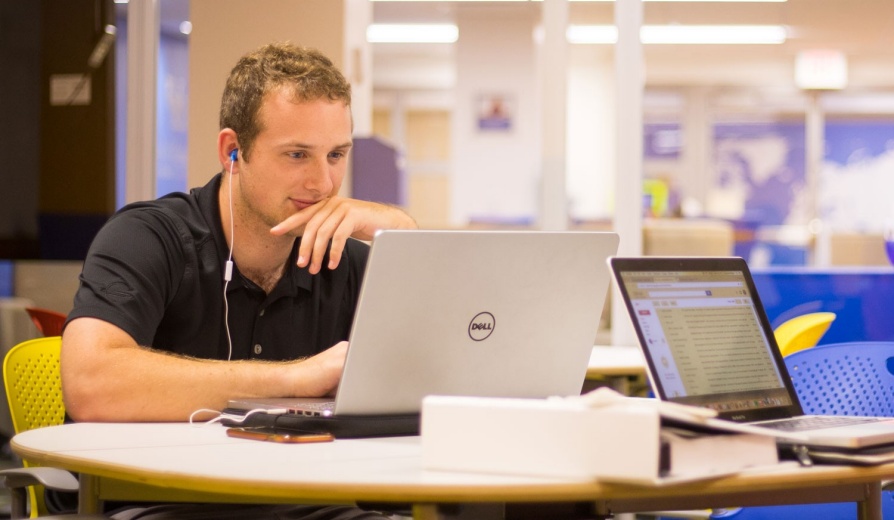 Student working at a laptop. 