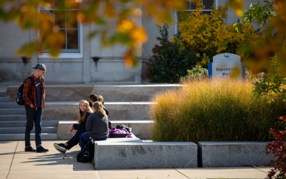 Students outside Harriman Hall on South Campus on a sunny day in fall, photographed in October 2019. Photographer: Meredith Forrest Kulwicki. 