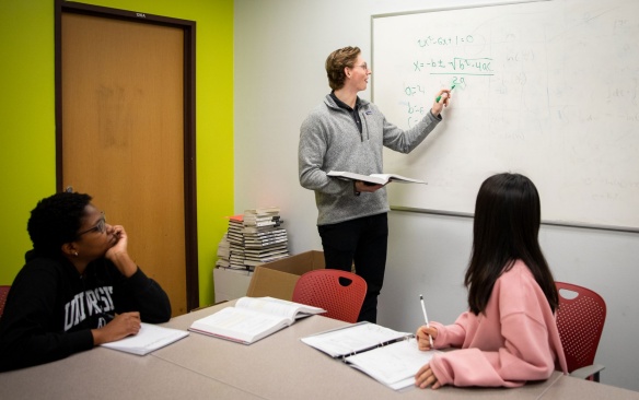 Student tutoring children. 