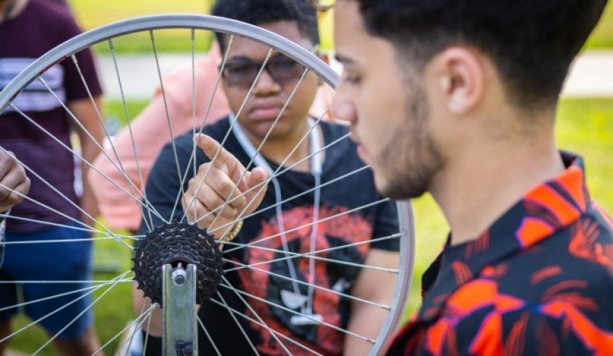 Student working on a bicycle. 