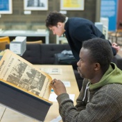 Students in Crystal Campbell’s media study class visit the Libraries Poetry Collection in Capen Hall in March 2024. Materials they interacted with included The Spectrum newspapers, university flags and banners, as well as other things. Photographer: Douglas Levere. 