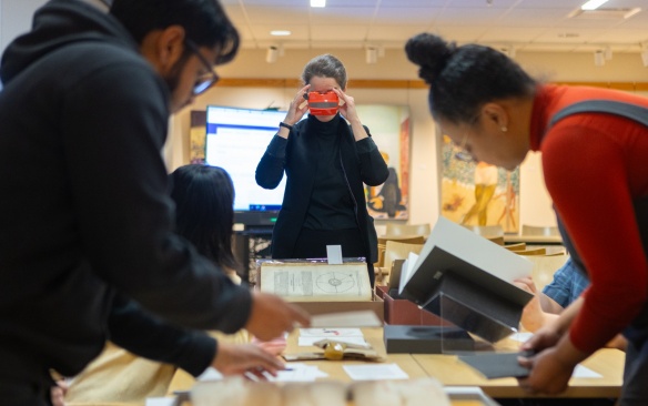 Students in Crystal Campbell’s media study class visit the Libraries Poetry Collection in Capen Hall in March 2024. Materials they interacted with included The Spectrum newspapers, university flags and banners, as well as other things. Photographer: Douglas Levere. 