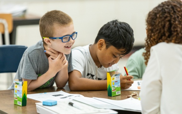 Two young students coloring. 