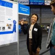 College student presents her research poster. 