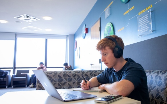 Student taking an exam on a laptop. 