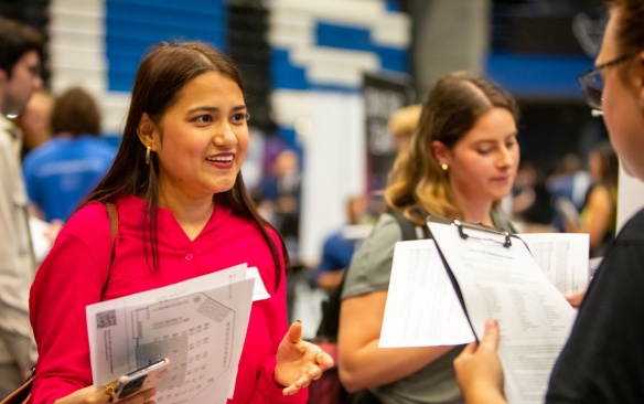 Female student at an internship fair. 