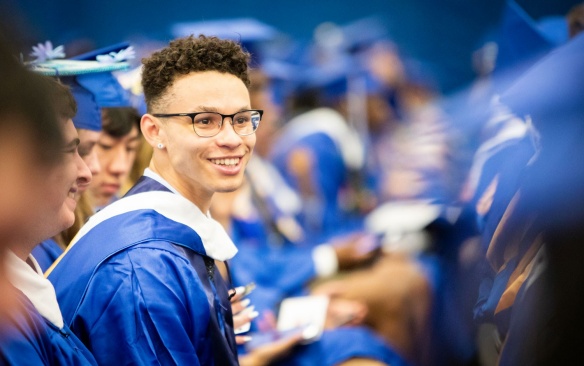 Male graduate at commencement ceremony. 