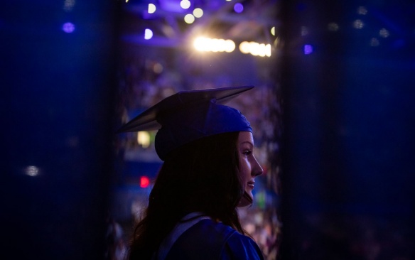 Female graduate in cap and gown at commencement. 