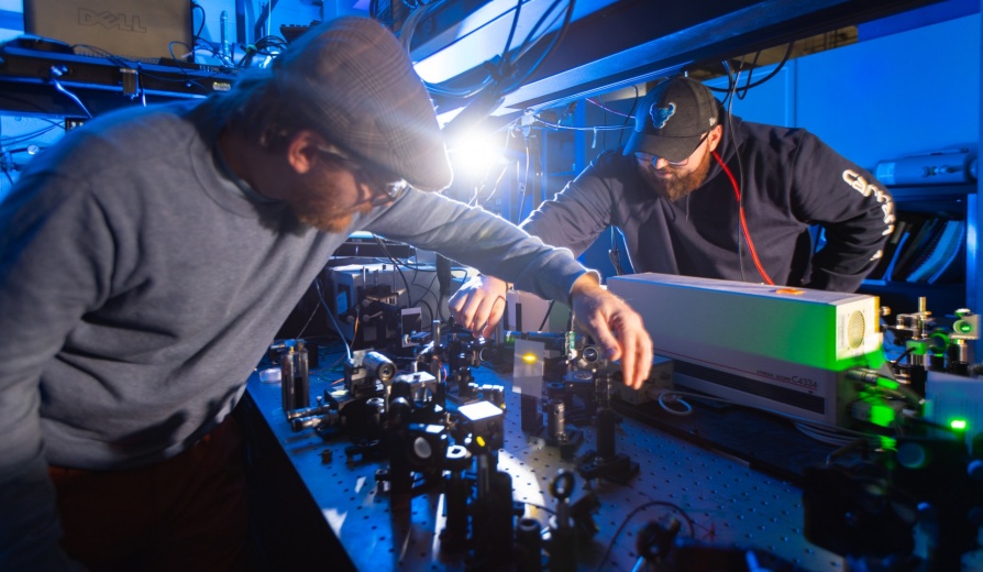 Tim Thomay, with physics, works with a student in his lab in Fronczak Hall in November 2023. Photographer: Douglas Levere. 