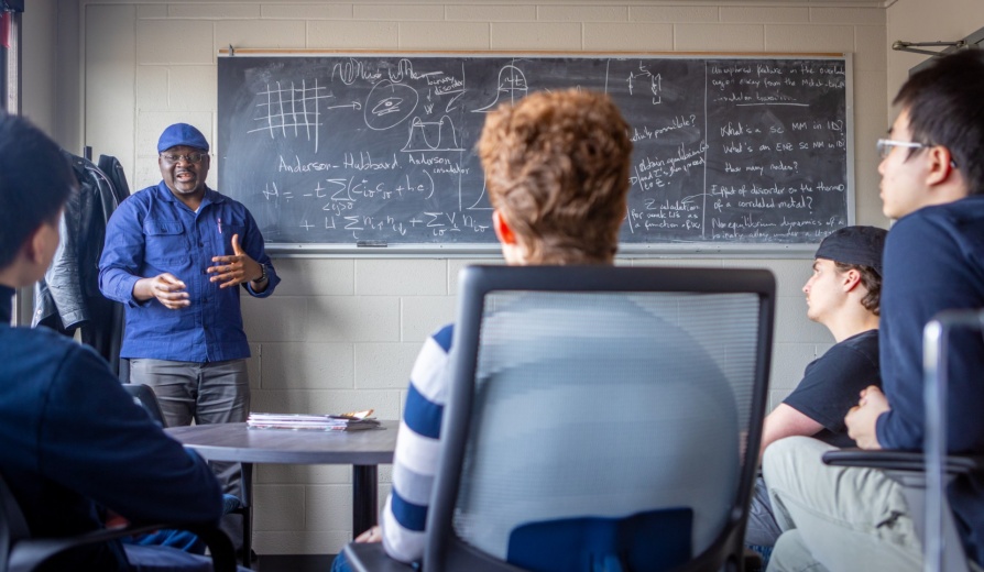 Herbert Fotso, with physics teaches in a graduate study meeting in Fronczak Hall in February 2024. Photographer: Douglas Levere. 