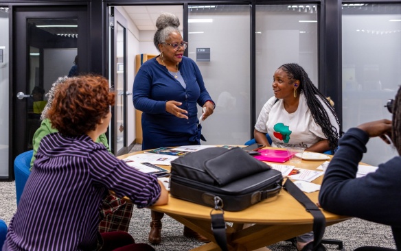 The 2023 Distinguished Visiting Scholars cohort meet with students during a mentor meeting in Baldy Hall in September 2023. Photographer: Douglas Levere. 