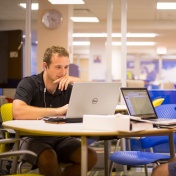 Student working at a laptop. 