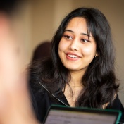 Smiling female student in class. 