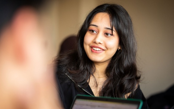 Smiling female student in class. 