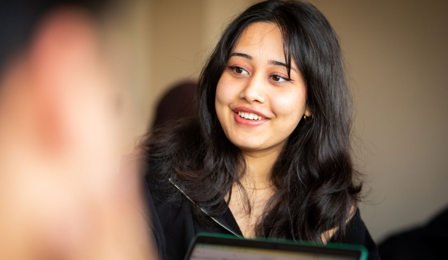 Smiling female student in class. 