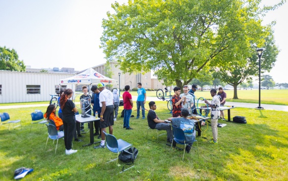 Students outside with tables and chairs. 