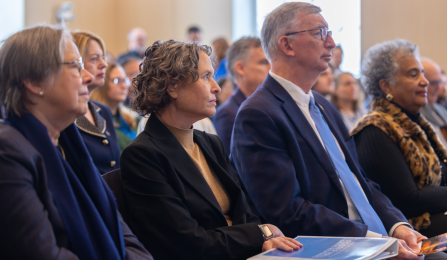 UB leadership sitting in rows listening to a lecturer.
