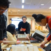 Librarian Archivist working with students and a collection in a library on UB's North Campus. 