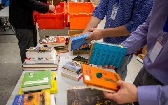 Adults organize children's books. 