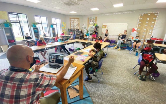 Rob Martin, EdM ’01, leads a 4th-grade class as he interviews a photojournalist by Zoom at the American International School of Lusaka in Zambia, March 2020. (Photo/Tony Potts). 