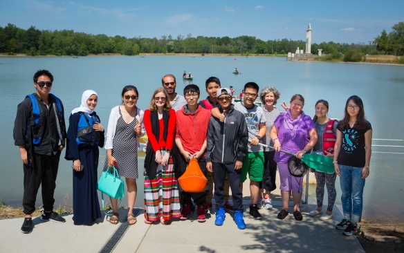 Diverse group of college students on a lake dock. 