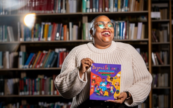 PhD student Dawnavyn James is photographed in December 2023 in the Lockwood Memorial Library. She is the author of "Beyond February: Teaching Black History Any Day, Every Day, and All Year Long," a guide for elementary school teachers — and those studying to be teachers. Photographer: Meredith Forrest Kulwicki. 