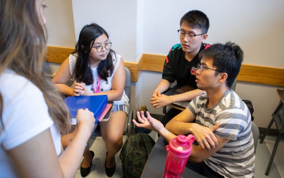 Teacher with students in a classroom. 