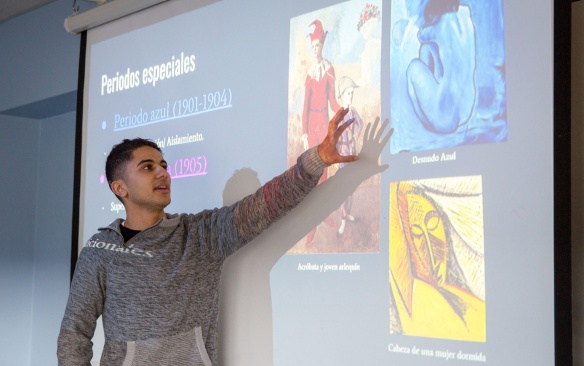 Student presenting in Spanish in a classroom. 