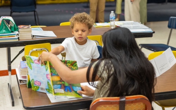 Teacher in an early childhood classroom with student. 