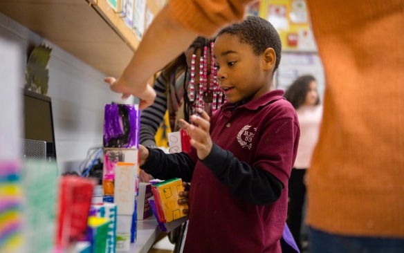 Volunteers with the Architecture + Education program work with student at Public School 53 in Buffalo, NY. Photographer: Douglas Levere. 