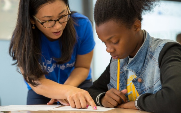 Ji-Won Son, the program director for the Summer Math Program interacts with students during an activity session on July 20, 2017. The program was held at the Buffalo Academy of Science in downtown Buffalo. Photographer: Meredith Forrest Kulwicki. 