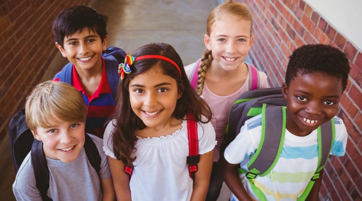 group of school age children in school yard. 