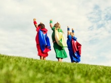 three children dressed in superhero costume. 