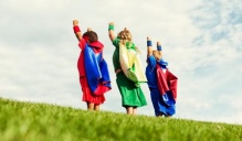 three children dressed in superhero costume. 