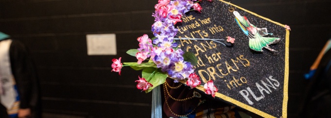 Image of a graduation cap reading "She turned her can'ts into cans and her dreams into plans. 
